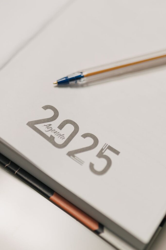 Minimalist 2025 agenda book with pen, perfect for planning and organization.